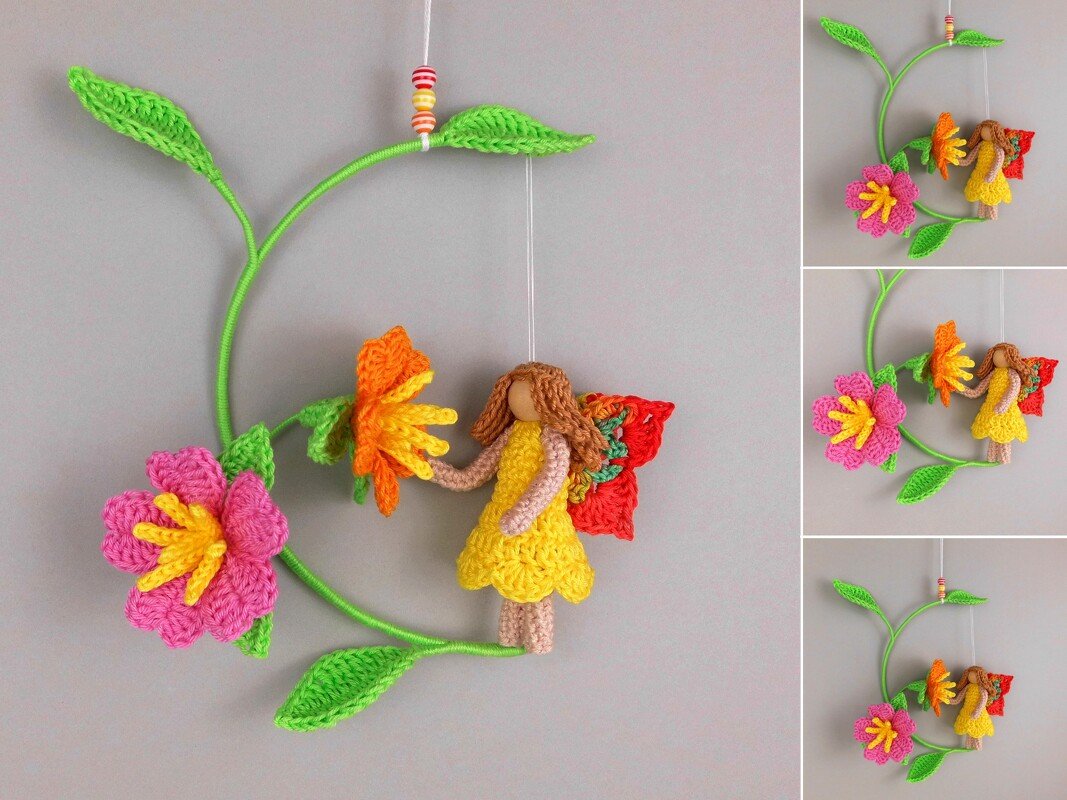 Crocheted fairy with wooden bead head hanging among pink and orange crocheted flowers on a green vine