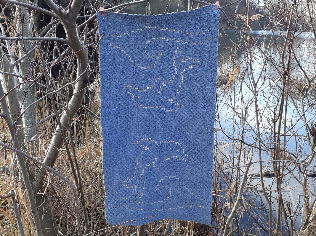 Coastal-inspired blue crochet panel with dolphin and bird openwork