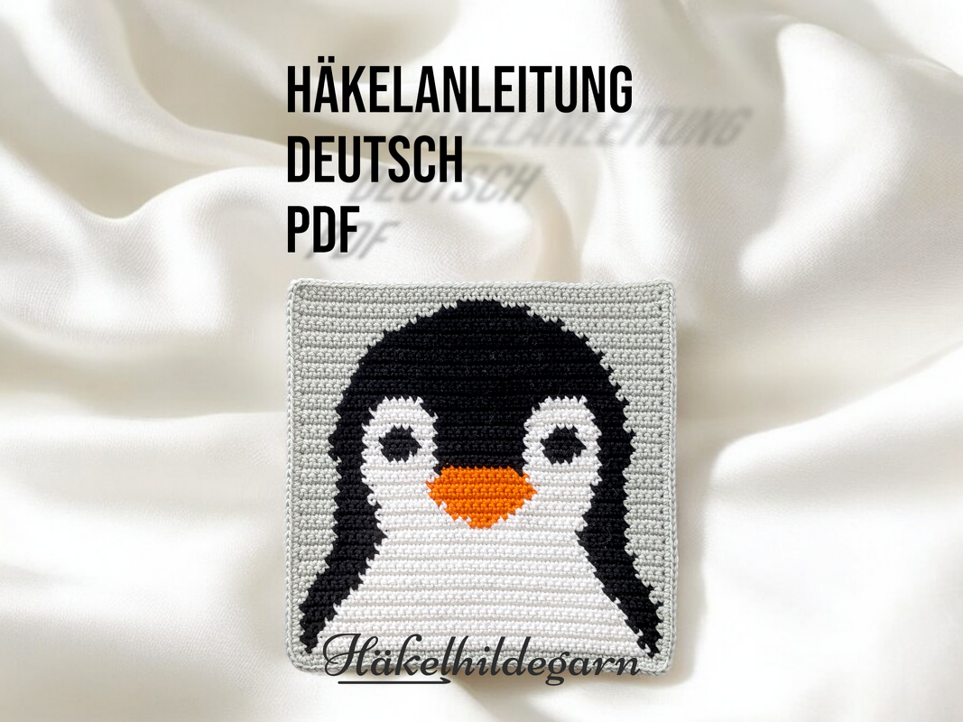 Quadratisches gehäkeltes Pixelmotiv eines Pinguins mit schwarzem Kopf, weißem Bauch und orangefarbenem Schnabel