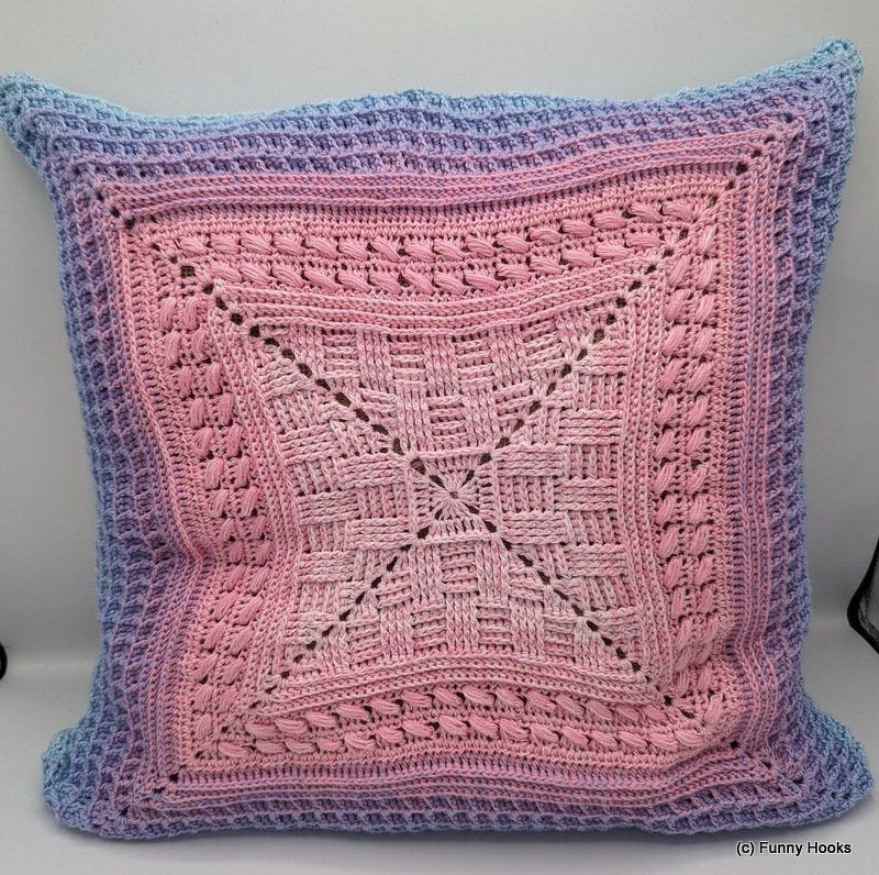 Quadratisches Häkelkissen in Rosa- und Blautönen mit Korbmuster und strukturierten Rändern