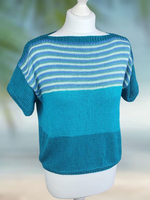 Gestricktes Damen-Kurzarmshirt mit U-Boot-Ausschnitt, kurzen Ärmeln und horizontalen Streifen in Blau, Türkis und Weiß auf einer Schaufensterpuppe.