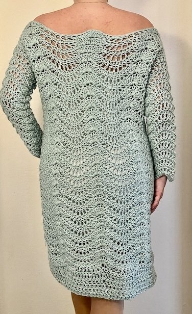 Back view of knee-length mint green crochet dress with wave lace pattern and long sleeves