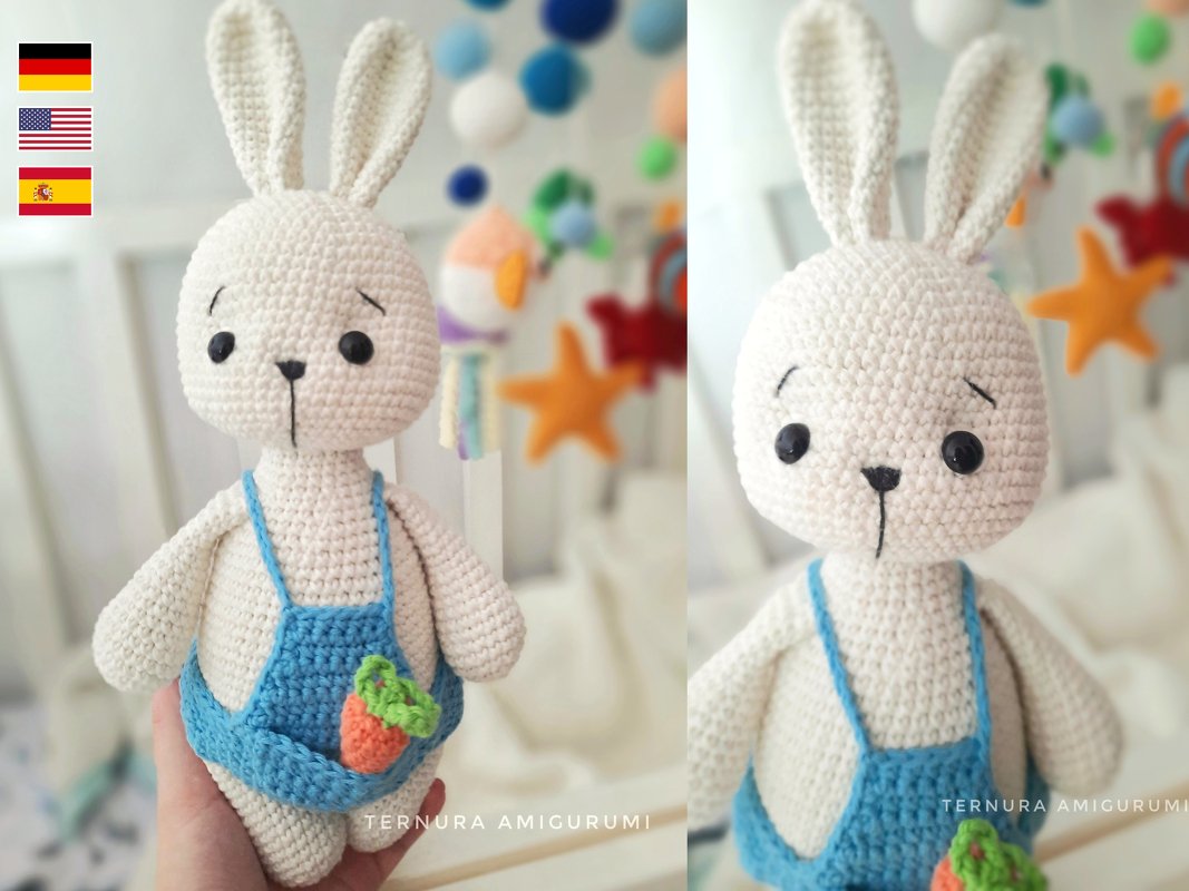 Cream crocheted amigurumi rabbit wearing blue overalls with carrot detail