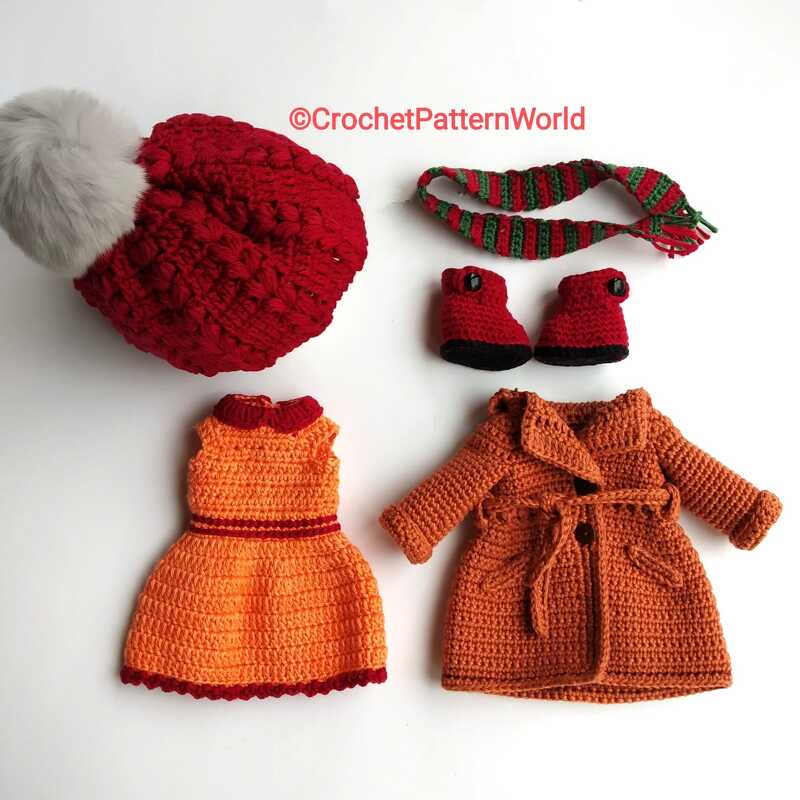 Crocheted doll clothes: orange dress, orange belted coat, red pompom hat, striped scarf and red boots