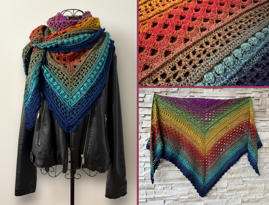 Rainbow gradient triangle crochet shawl with bobble and lacy openwork, draped on a black jacket.