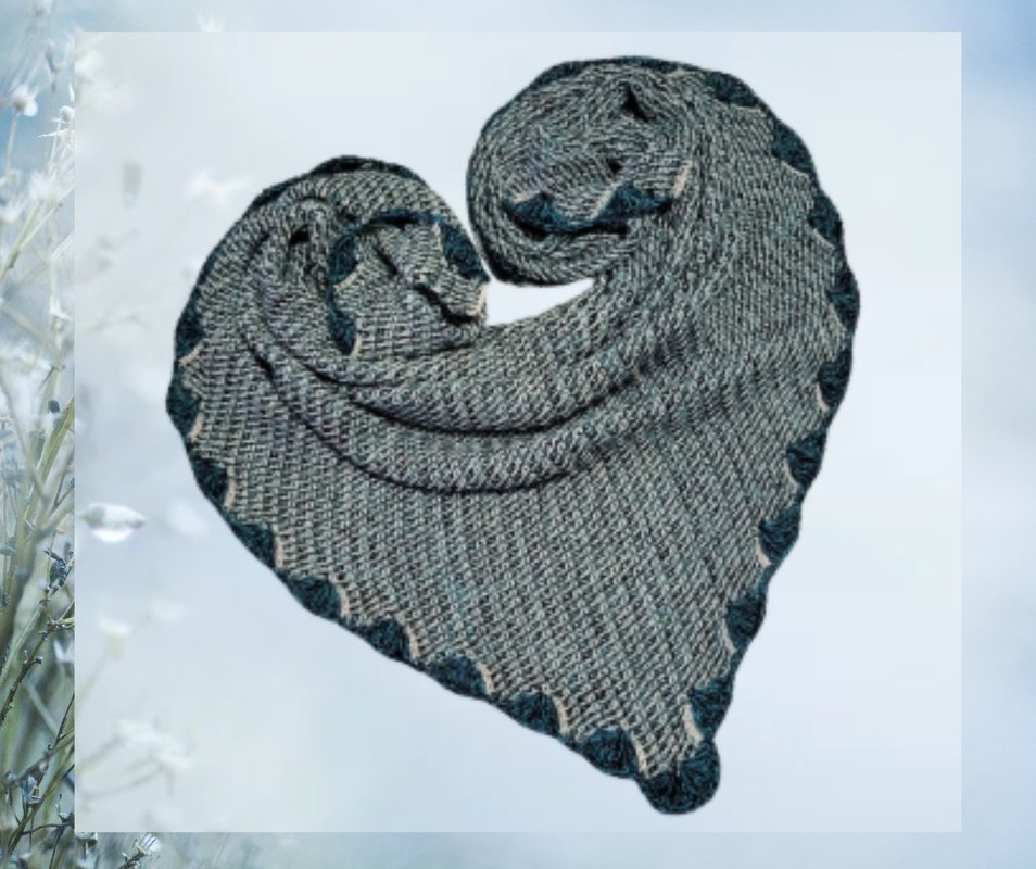 Grey and dark teal crochet triangle shawl folded into a heart showing scalloped edge and textured stitch.
