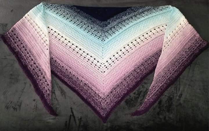 crocheted triangle shawl with pastel ombre gradient and eyelet rows