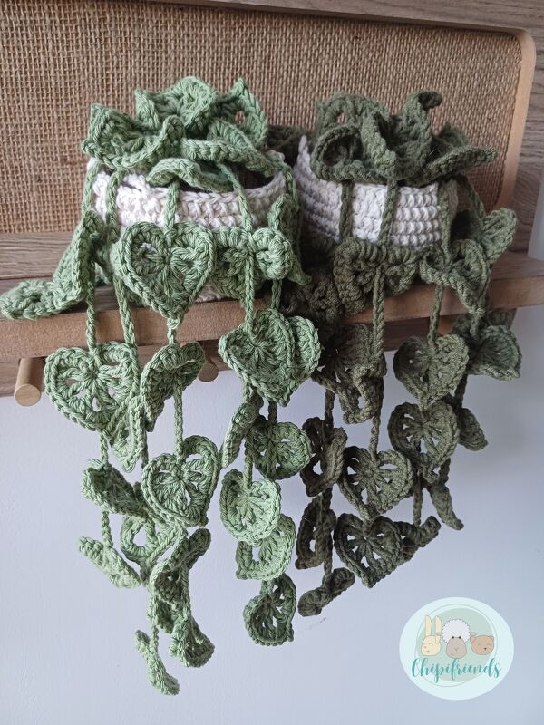 Two crocheted hanging planter covers with cascading heart-shaped leaves in light and dark green