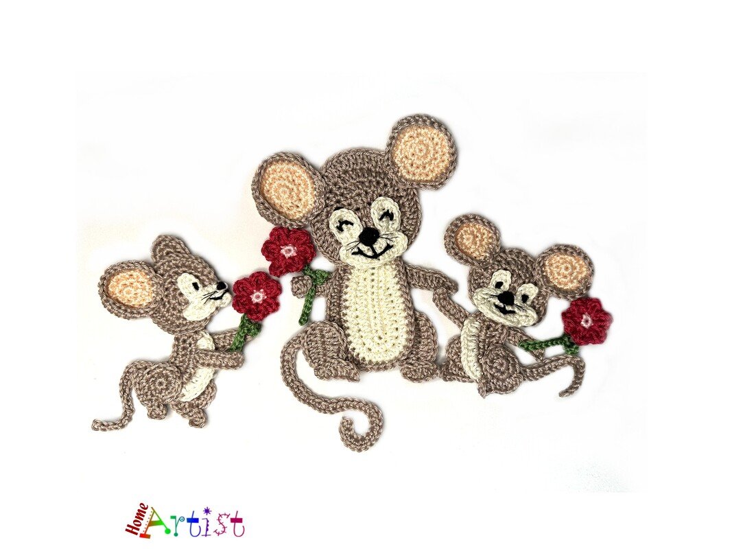 Three flat crocheted mouse appliqués in brown and cream, each holding a red flower, on a white background.