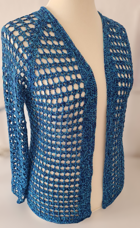 Gehäkelte blaue Damenjacke mit offenem Netzmuster auf einer Schneiderpuppe