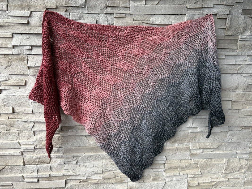 Ombre triangle crochet shawl in red, pink and gray with geometric openwork