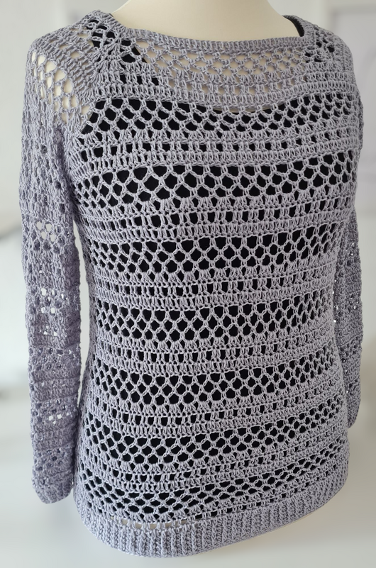 Hellgrauer gehäkelter Damenpullover mit Ajourmuster auf Schaufensterpuppe