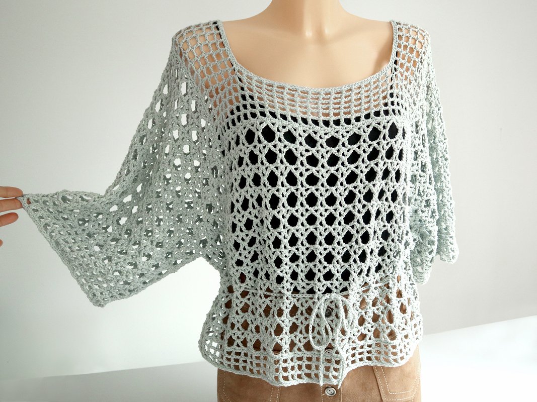 Light grey openwork crochet tunic with drawstring hem on mannequin
