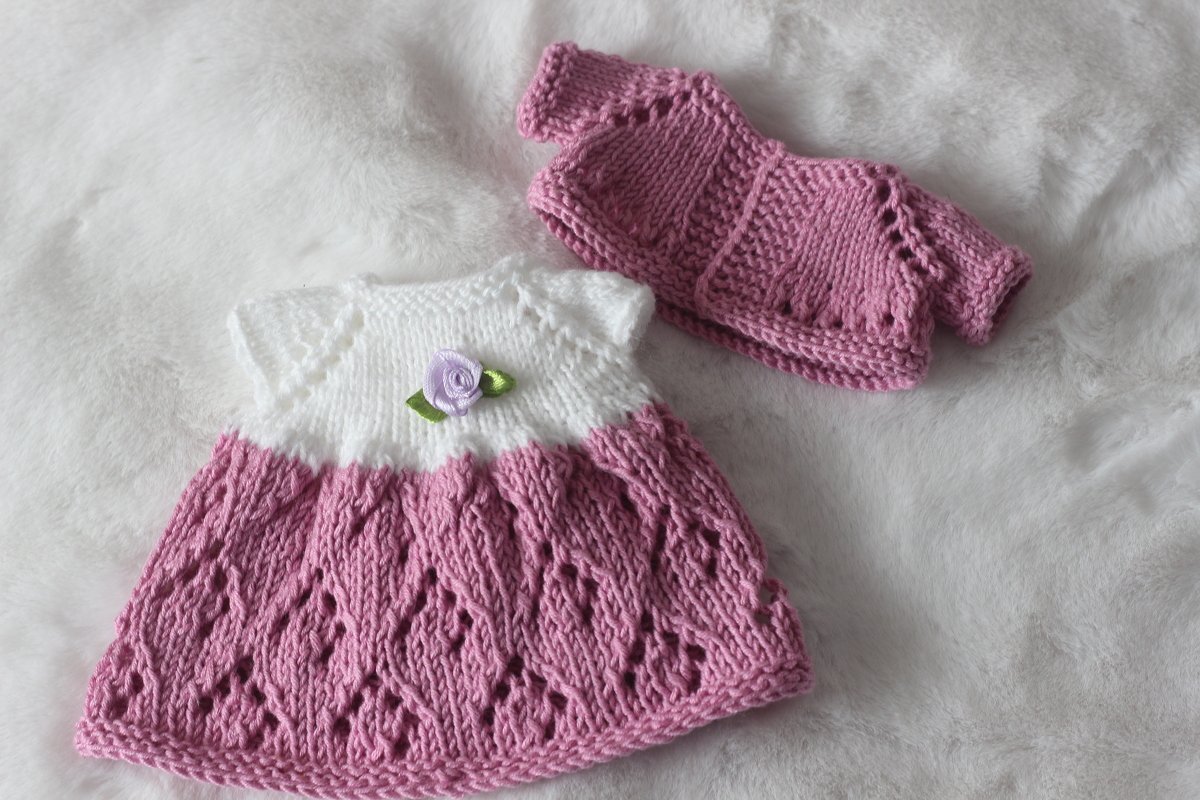 Pink lace-pattern knitted doll dress with white short-sleeve yoke and matching pink cardigan