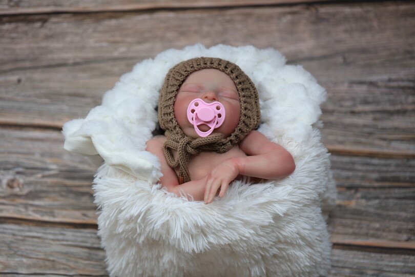 Whirlwind knitted bonnet in a spiral pattern
