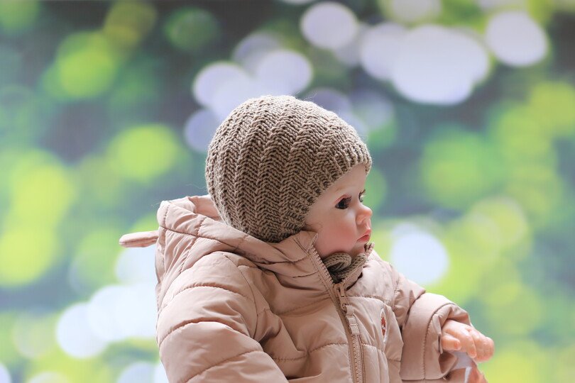 Whirlwind knitted bonnet in a spiral pattern