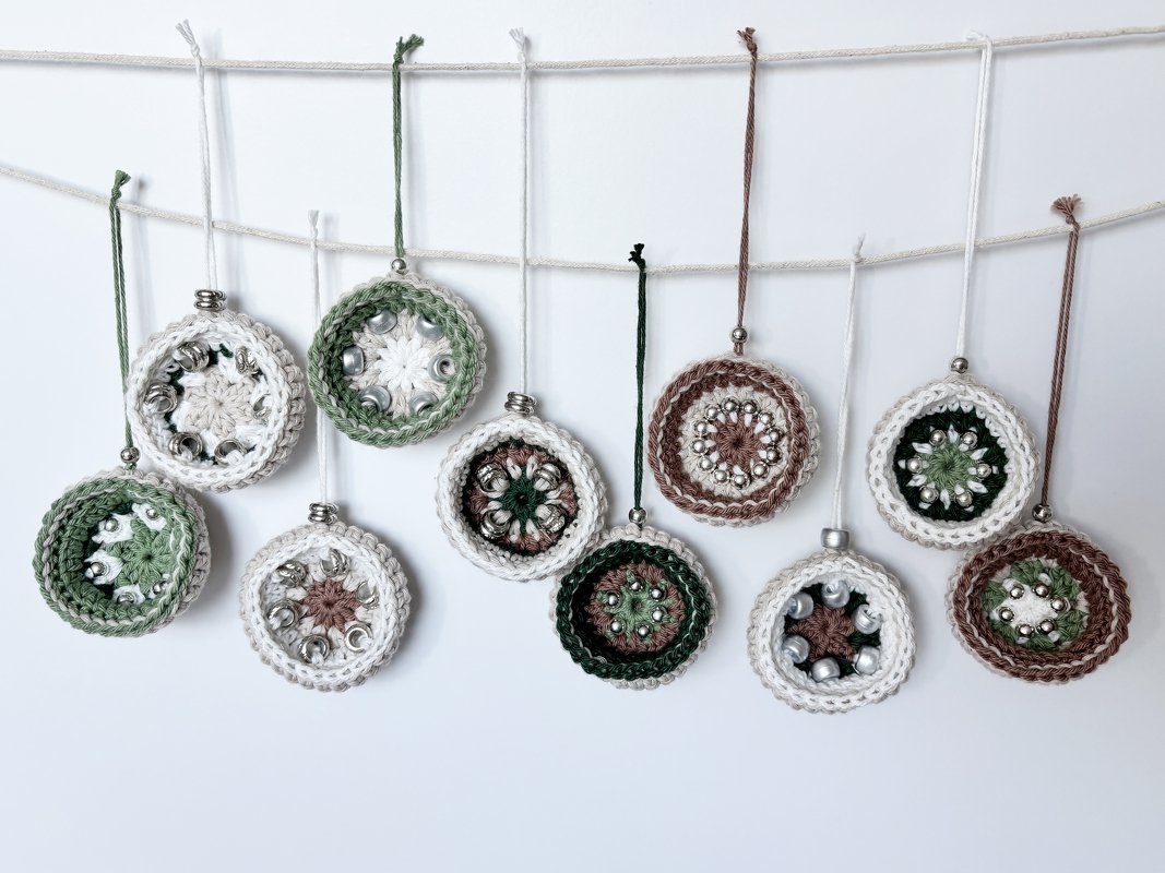 Small beaded crochet ornaments in green, brown and white strung on a cord