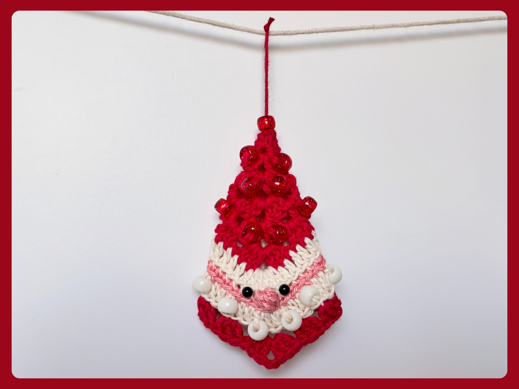 Compact granny-motif Santa crochet ornament in red and white with bead embellishments