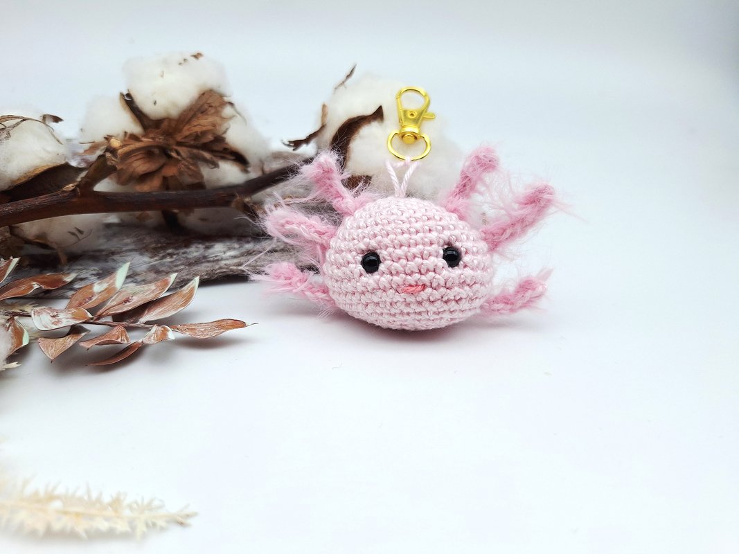 Rosa gehäkelter Axolotl-Schlüsselanhänger mit goldfarbenem Karabiner
