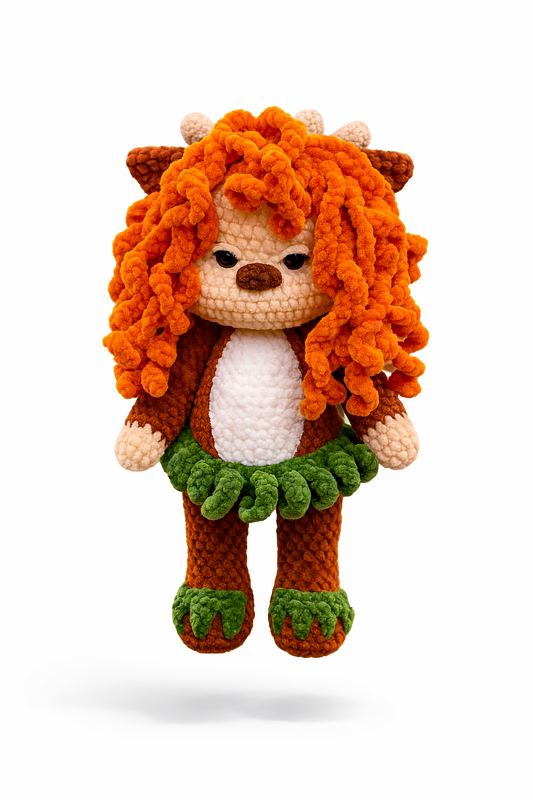 Crocheted amigurumi lion with curly orange mane, white belly, and green ruffle skirt